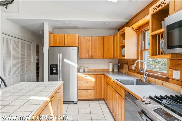 Guest house features kitchen propane stove, stainless steel appliances and beautiful natural light