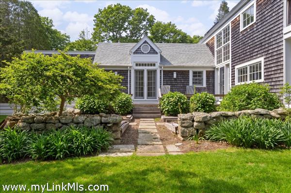 Beatiful landscaping with stairs leading to primary bedroom