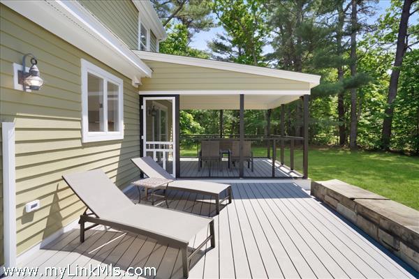 Sun deck between the screened in porch and patio/barbecue area