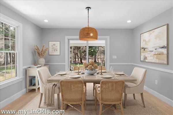 Dining room conveniently located between the living room and kitchen, with sliders out to the porch. Virtually staged.