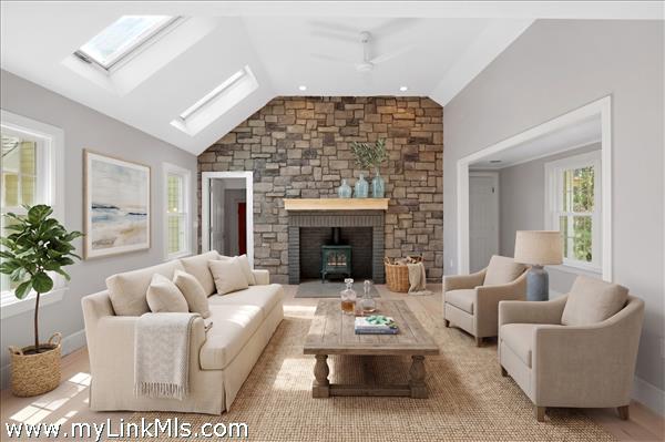 Inviting family room with cathedral ceiling, sky lights, propane stove and access to garage on the left and variable use office/game room to  the right. Virtually staged.