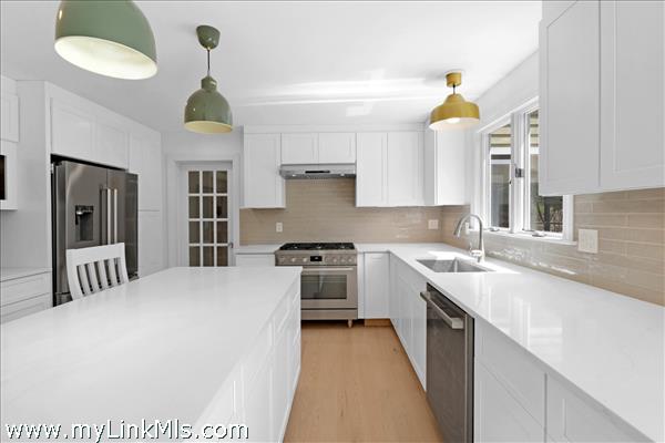 Gourmet kitchen with center island, french door to dining room.