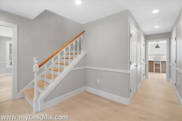 Front entrance foyer with living room to the left and hallway to kitchen, powder room and 1st floor bedroom on the right.