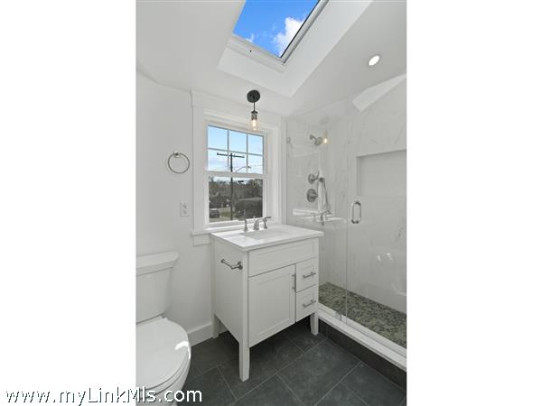 Luxurious full bathroom highlighted by Quartz and stone and glass finishings on second level in primary unit.