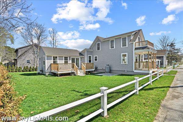Luscious side yard and outdoor living area, privacy fencing and sidewalk to town.