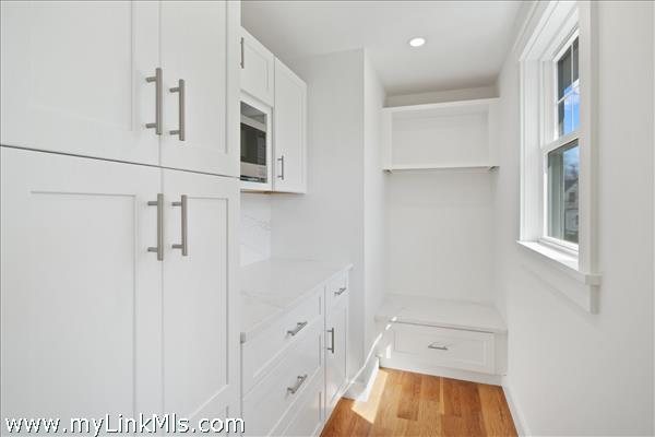 Chef's pantry doubles as dry bar and/or coffee station with extra storage.
