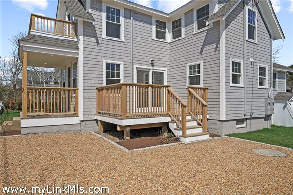 Primary residence - deck, parking, covered front porch and second floor balcony.