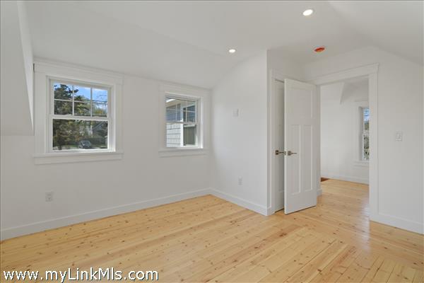 Main bedroom in primary unit with hardwood oak flooring and climate control.