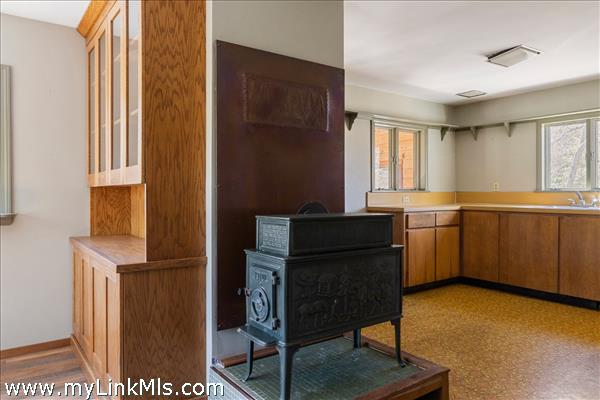 Wood stove between kitchen and dining room