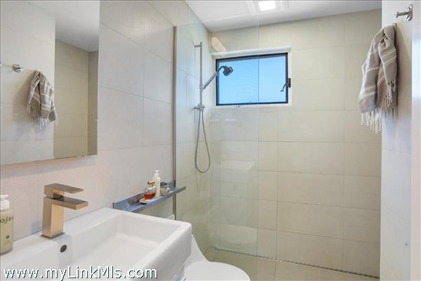 Both renovated bathrooms have tiled walk-in showers.