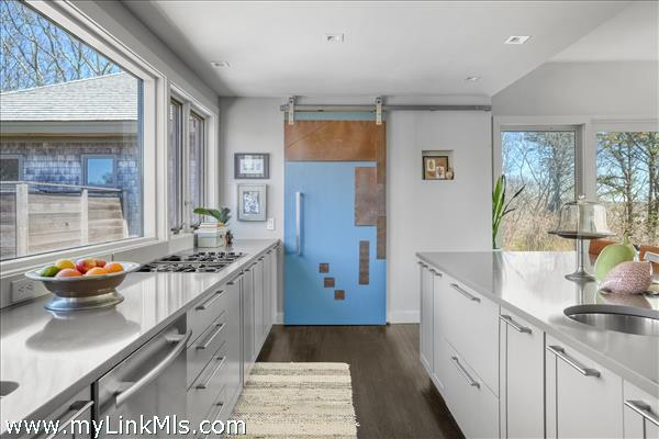 Decorative barn door conceals a generous pantry space.