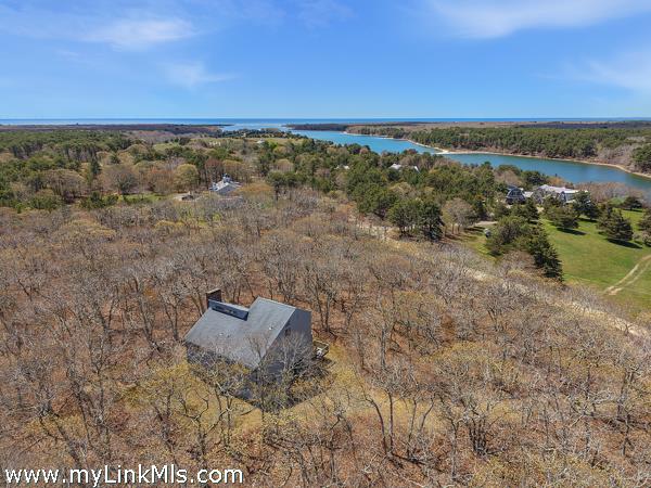 Nestled privately on 4.4 acres. A very short stroll to the pond.