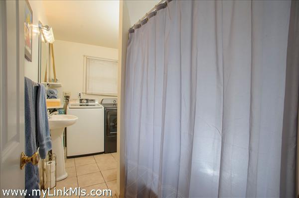 First floor bathroom with washer and dryer