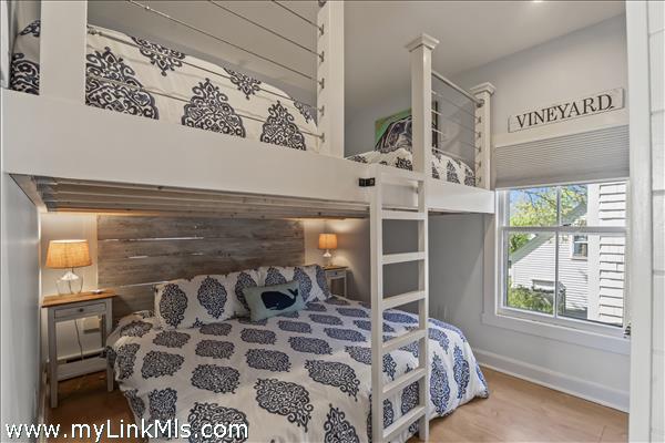 Bedroom with loft bunks over king bed