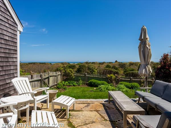 Private patio off of the primary bedroom with broad ocean views.