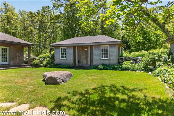 A detached, unfinished bonus structure offers a blank canvas with incredible potential that could be easily transformable into a private guest bunkhouse, a serene home office, or an artist’s studio