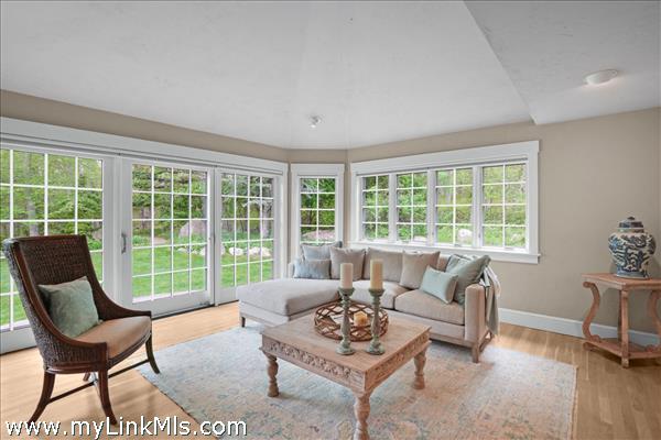 nviting, bright sunroom that serves as the perfect year-round oasis for morning coffee, casual reading, or unwinding while fully immersed in the surrounding nature