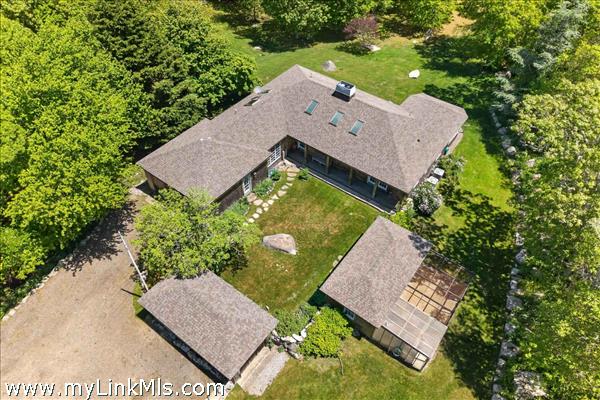 An aerial view showcases the home’s striking pavilion-style architecture, centered around a private, sunlit courtyard and surrounded by lush greenery