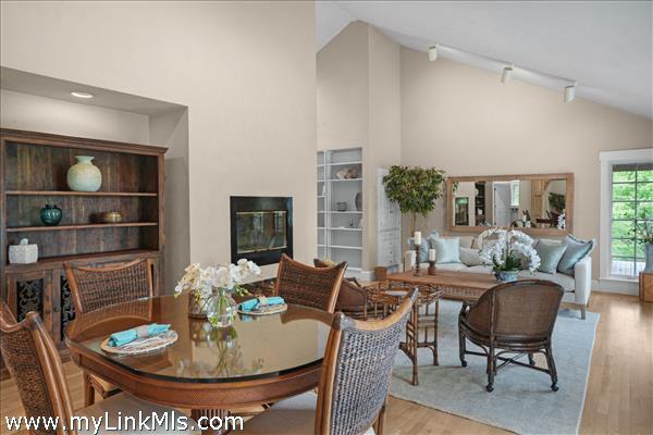 Open living/dining area with fireplace