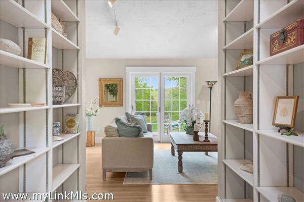 A welcoming foyer features timeless custom built-in bookshelves, perfect for showcasing a curated library or personal treasures