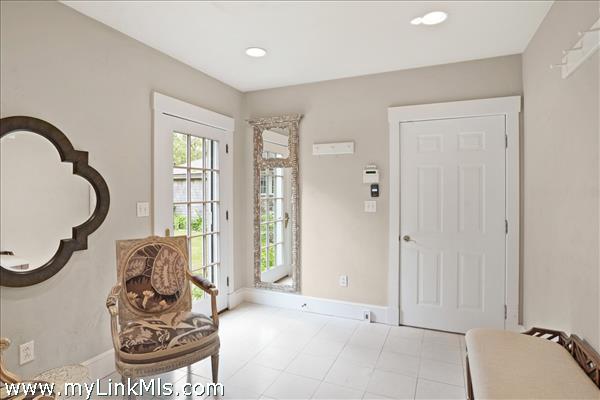 A bright and functional mudroom is conveniently located just off the attached one-car garage