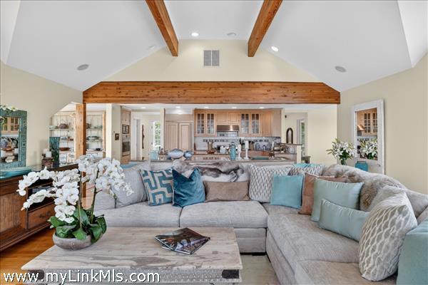 Living room that is light and bright with exposed beams