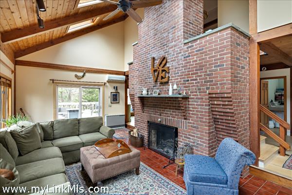 Floor-ceiling brick wood-burning fireplace