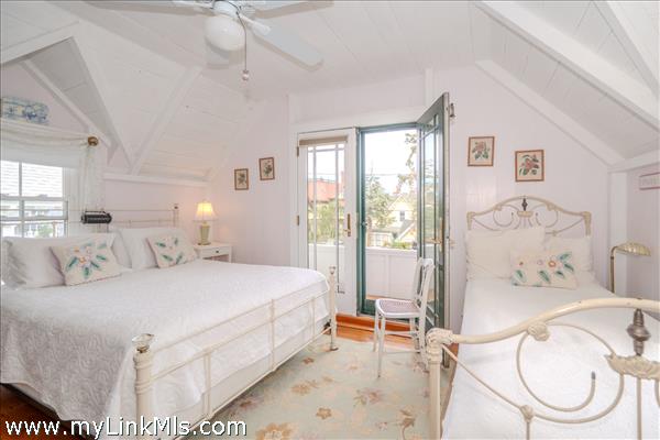 Primary bedroom features a high ceiling and an airy, light filled atmosphere.