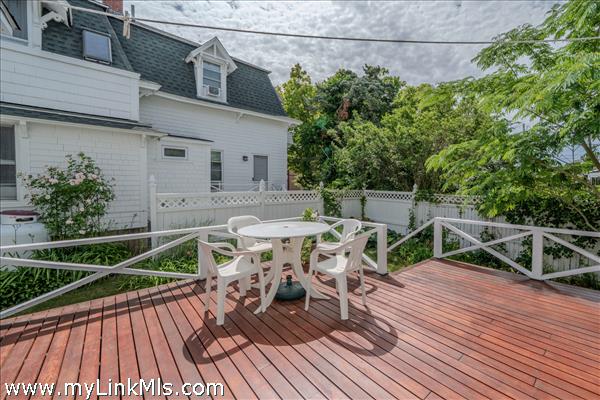 Newly stained mahogany  deck overlooking backyard