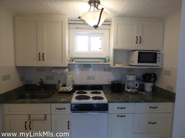 Kitchen with full size refrigerator, 4 burner electric oven, microwave