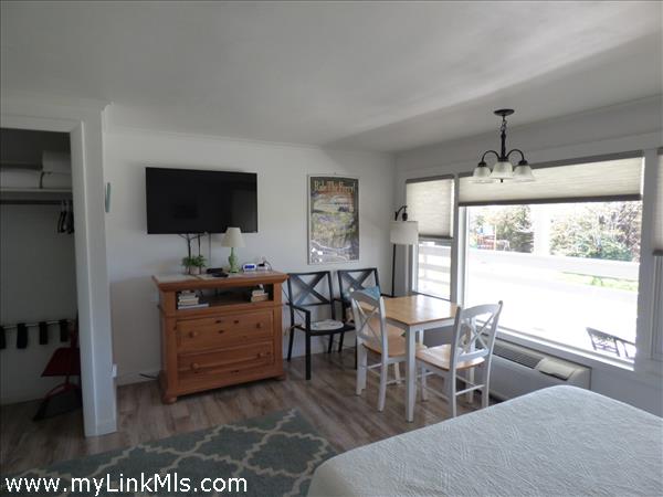 Upon entering, there is small sitting area. Table and chairs. TV