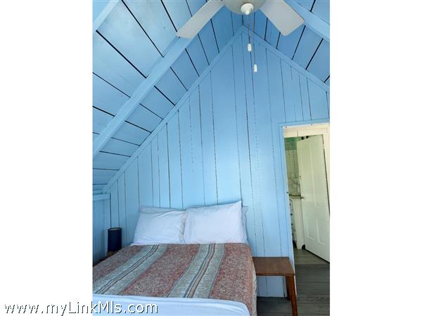 Beautiful blue bedroom with serene coastal decor and natural light.