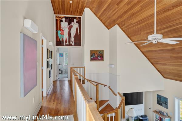 The second floor offers three guest rooms and a full bathroom.