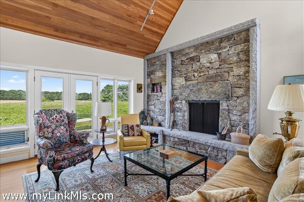 The living room features a Lew French stone fireplace.