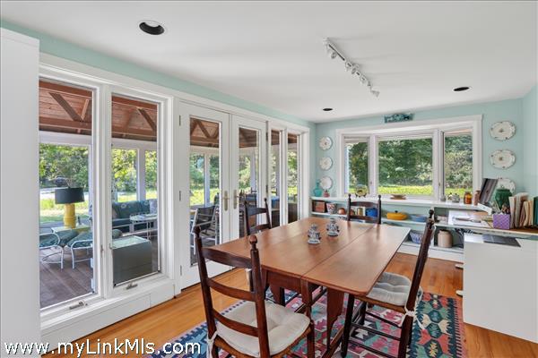 The dining room opens onto the sunroom/porch.
