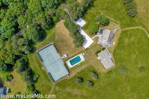 30 Elias Lane offers a main house, guest house, pool and private tennis courrt.