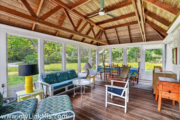 The sunroom/porch offers additional space for entertaining and enjoyment.