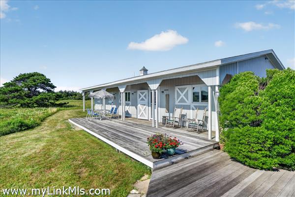 The two bedroom guest house has a lovely front porch.