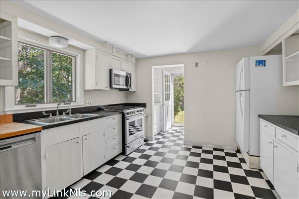 Kitchen view into laundry area and side door