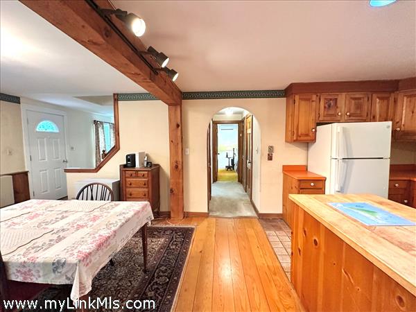 Side door to kitchen, dining, full bath, hallway and first floor bedroom