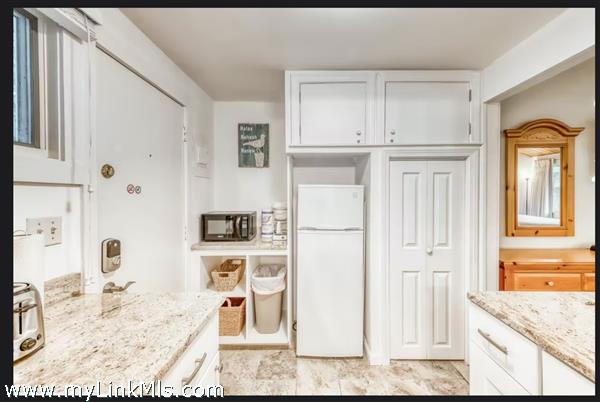 Kitchenette with Refrigerator and Storage Area