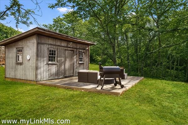 Large shed with concrete patio