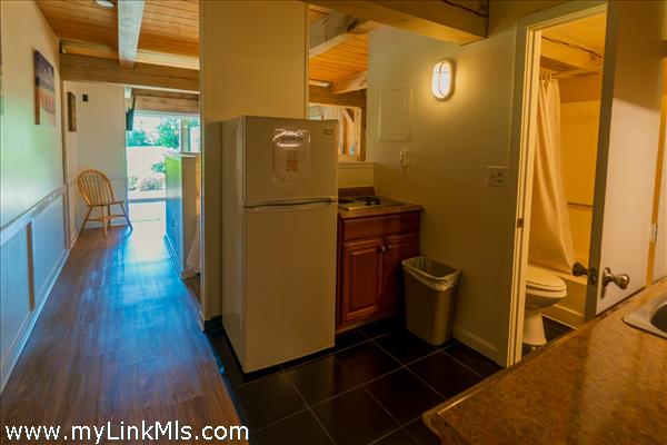 small kitchen and hallway to living room and more beds