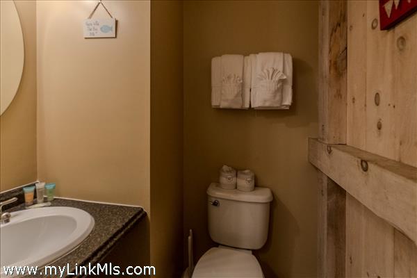 Half bathroom located within the bedroom.