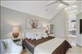 Primary bedroom with beamed cathedral ceilings, en suite bath & walk-in closet.