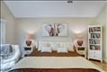 Primary bedroom with beamed cathedral ceilings, en suite bath & walk-in closet.