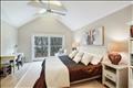 Primary bedroom with beamed cathedral ceilings, en suite bath & walk-in closet.