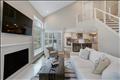 Light-filled living area with wood fireplace.