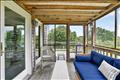 Wrap-around deck leads to the screened porch.
