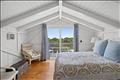 Second floor primary with en suite bath and private deck.